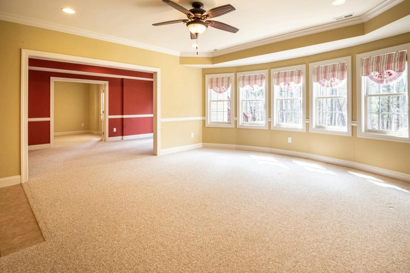 Bright empty room with carpet and ceiling fan ideal for resi 1774976520
