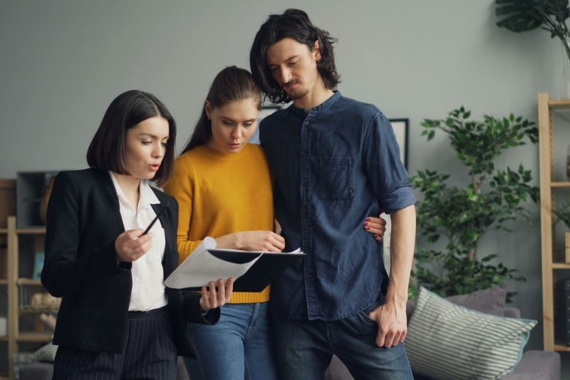 VA Home - 1 2 A couple reviewing documents with a real estate agent indoor 1781629493