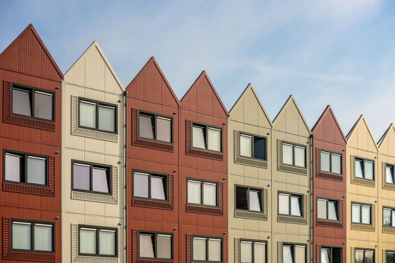 VA Home - 1 27 A vibrant row of gableroofed residential buildings with meta 1782838821