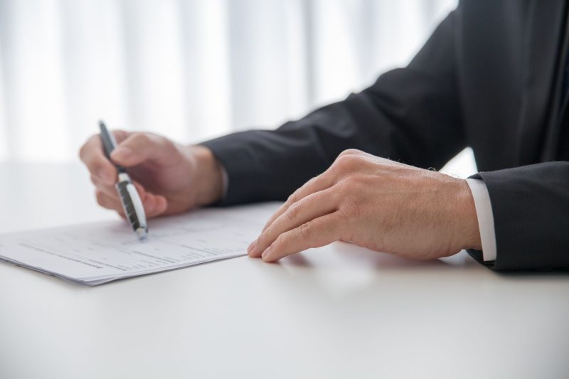 VA Home - 1 27 Businessman signing important documents at office desk 1785258602
