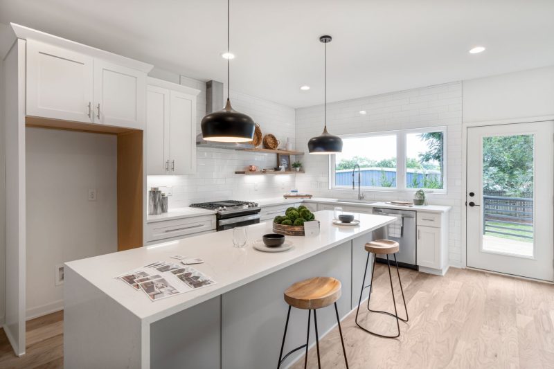 VA Home - 1 27 Bright modern kitchen with white cabinetry wooden stools and 1792515725